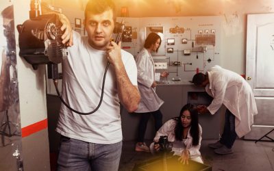 Guy checking telephone in escape room Guy checking telephone set while trying to get out with friends of escape room stylized as underground shelter