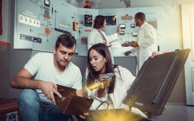 Girl and guy with box in escape room Focused girl and guy viewing contents of box while trying to get out of escape room stylized as underground shelter